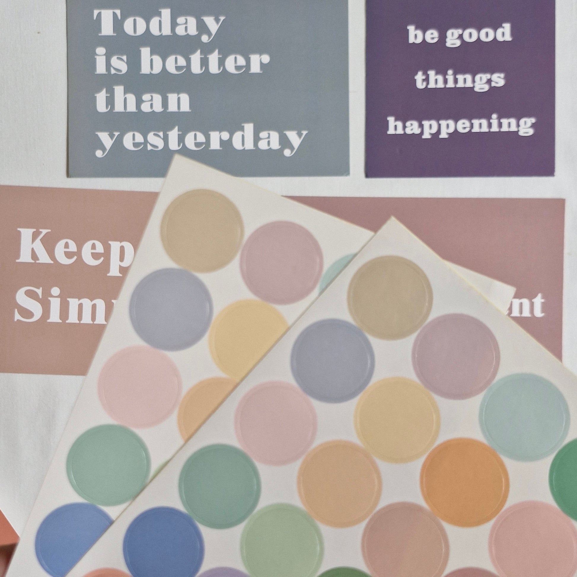 Motivational posters with text and a colorful polka dot design.