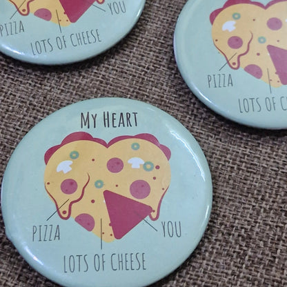 Four round buttons with pizza design and text on a textured surface