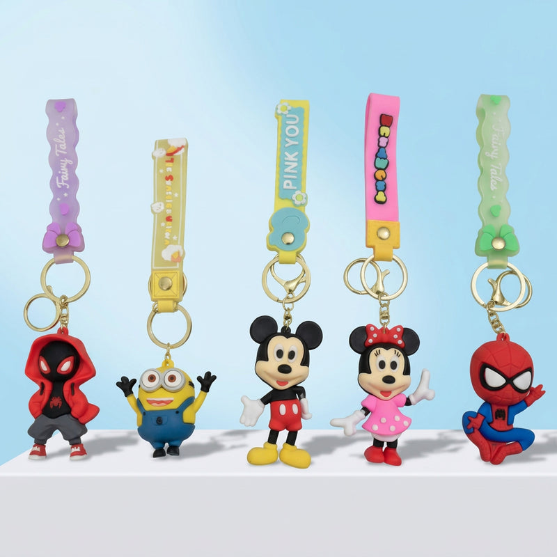 Set of colorful keychains featuring cartoon characters on a light blue background with star and cloud decorations.